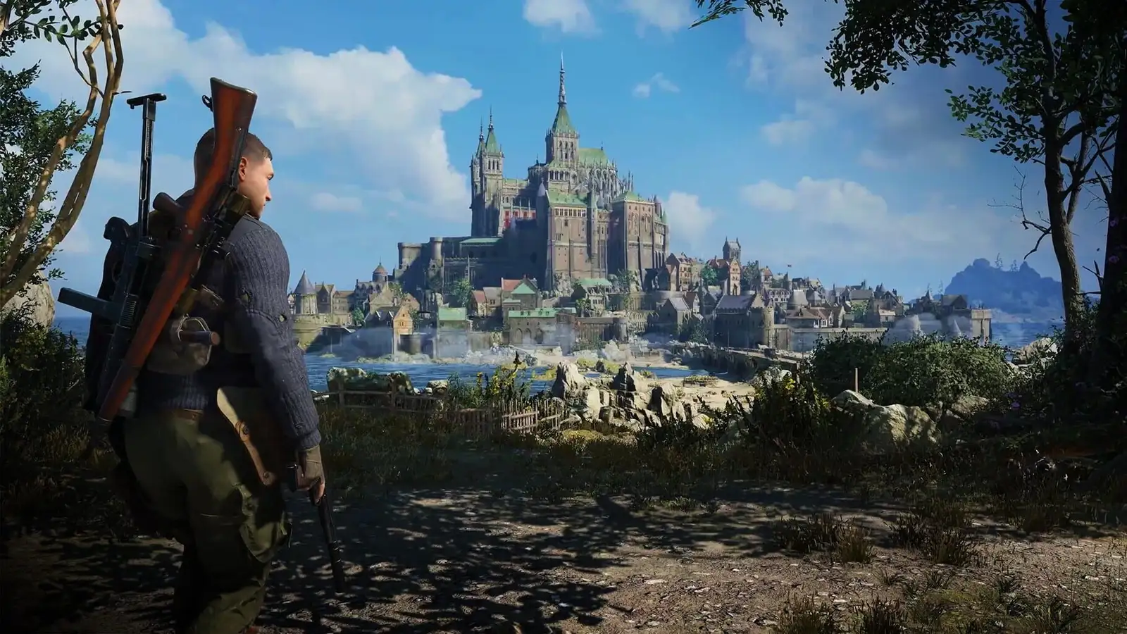 Screenshot of Sniper Elite 5 video game, with the main character looking towards a large castle/church like building set along the coast of France.